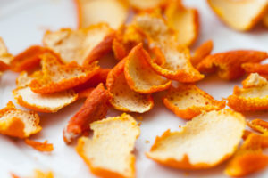 dried orange zests on white background