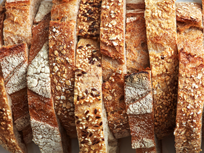 Macro photos of slices of homemade, grain bread with sesame seeds and flax. Organic Healthy Food. Flat lay