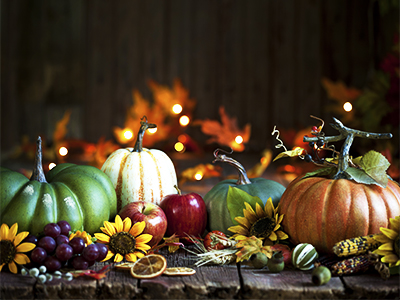 Autumn Thanksgiving pumpkin and leaf arrangement on old wood background