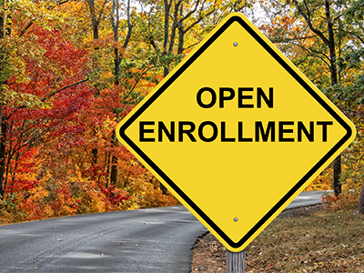 Open Enrollment Caution Sign With Autumn Road Background