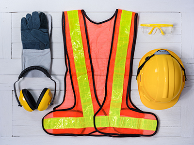 Standard construction safety equipment on white wooden background. top view, safety first concepts