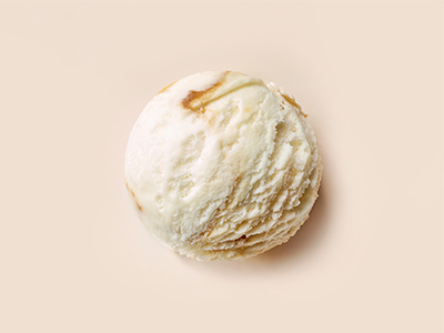 caramel and vanilla ice cream ball on beige background